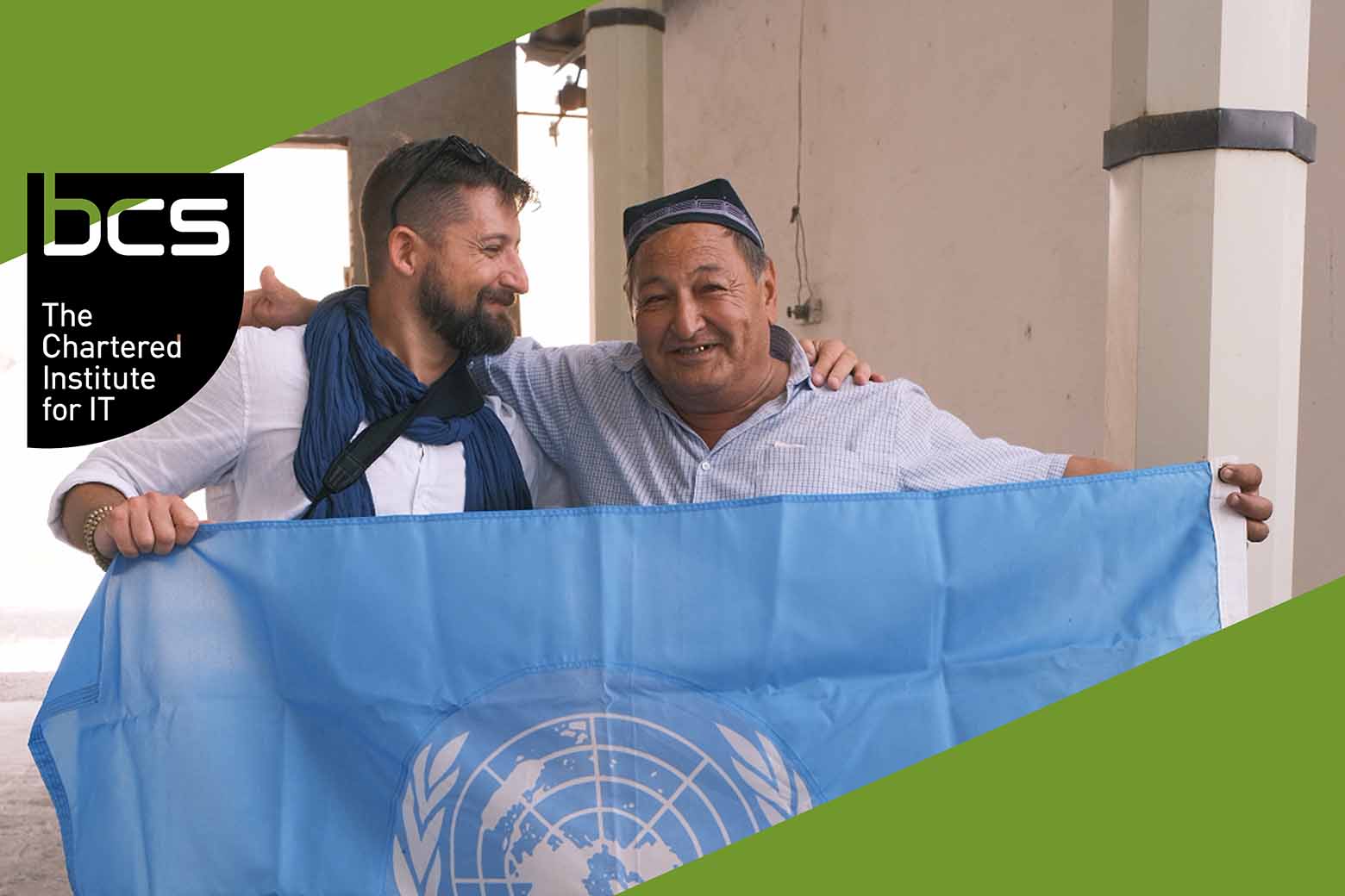 Pastoral founder Josh Thomas and farmer partner Abduvali Holteraev hold a UN flag